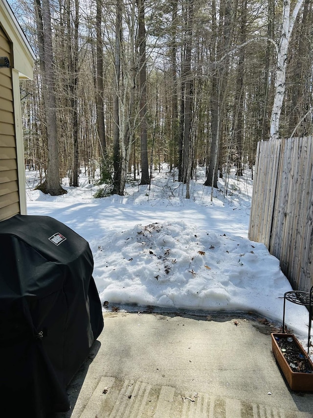 yard covered in snow with fence