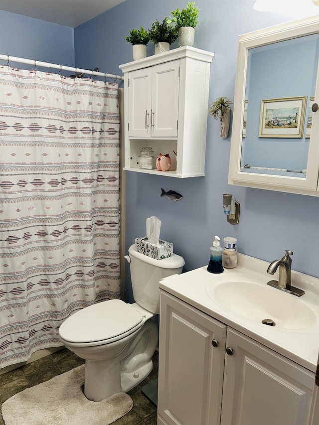 bathroom with a shower with shower curtain, stone finish flooring, toilet, and vanity