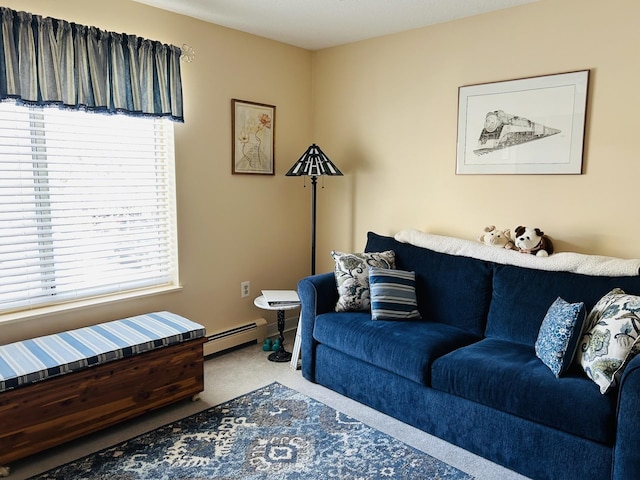 living area with a baseboard heating unit and carpet