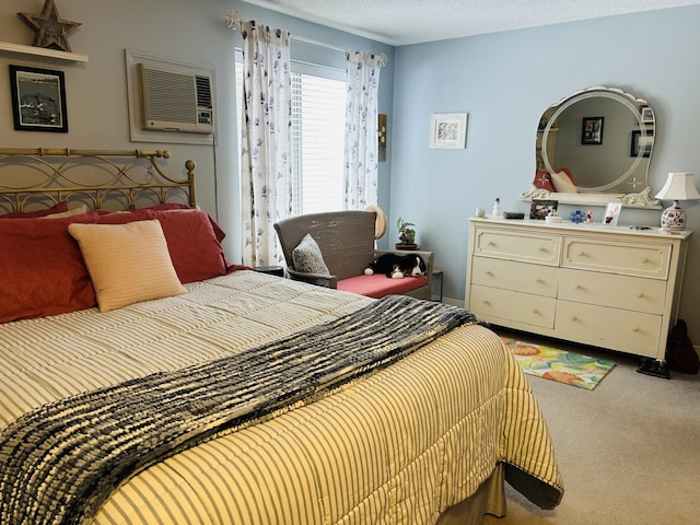 carpeted bedroom with a wall unit AC and a textured ceiling