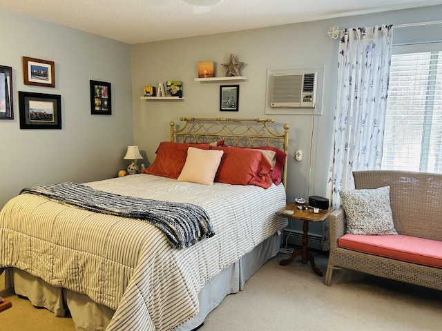 bedroom featuring a baseboard heating unit, carpet, and a wall mounted air conditioner