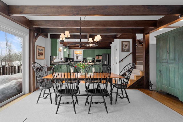 dining space with stairway, beam ceiling, an inviting chandelier, and light wood finished floors