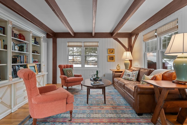 living room with beamed ceiling and wood finished floors