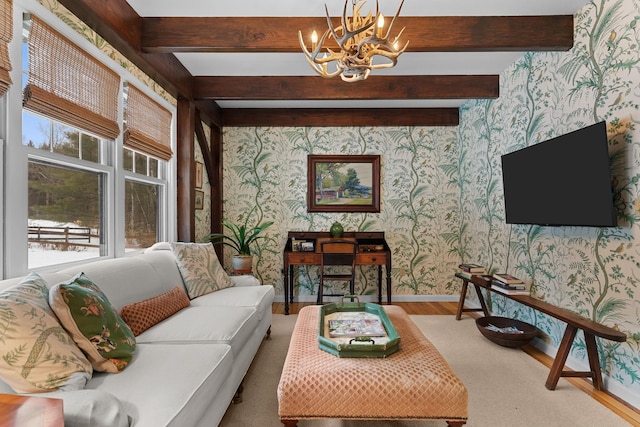 living room featuring wallpapered walls, wood finished floors, a healthy amount of sunlight, and baseboards