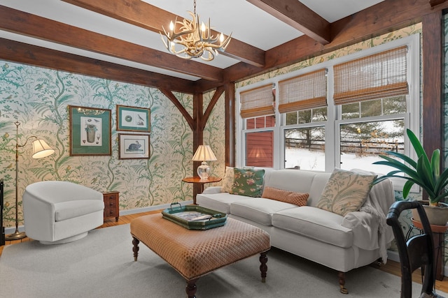 living area with beamed ceiling, wood finished floors, wallpapered walls, baseboards, and a chandelier