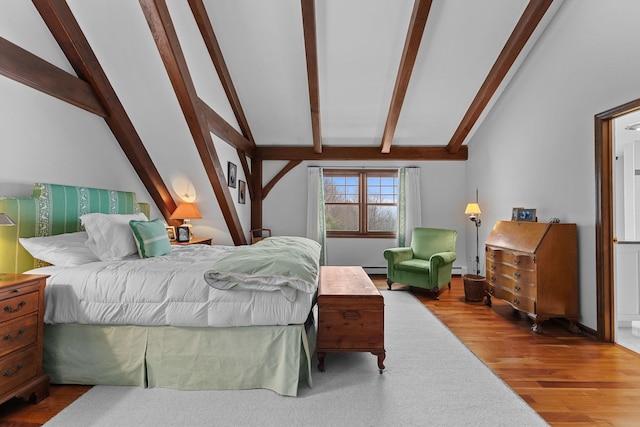 bedroom with vaulted ceiling with beams, a baseboard heating unit, and wood finished floors