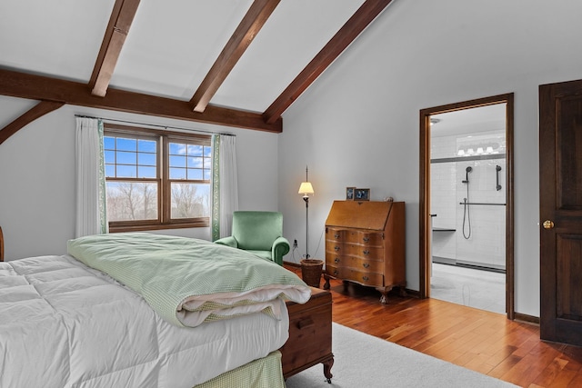 bedroom with connected bathroom, vaulted ceiling with beams, baseboards, and wood finished floors