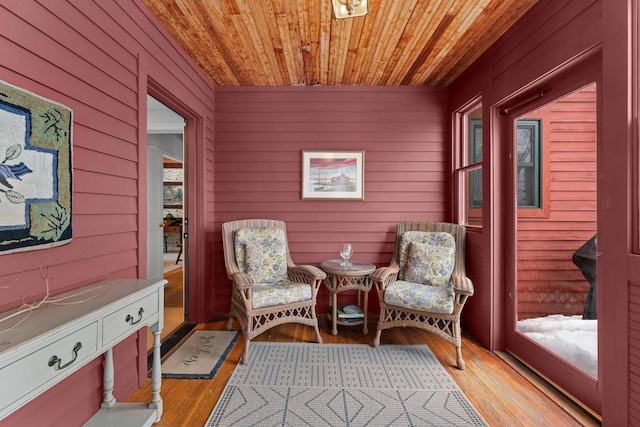 sitting room featuring light wood finished floors and wooden ceiling