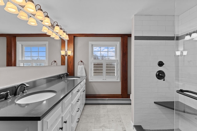 full bath featuring a sink, a baseboard radiator, double vanity, and a tile shower