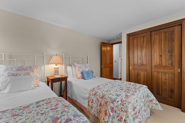 carpeted bedroom with a closet