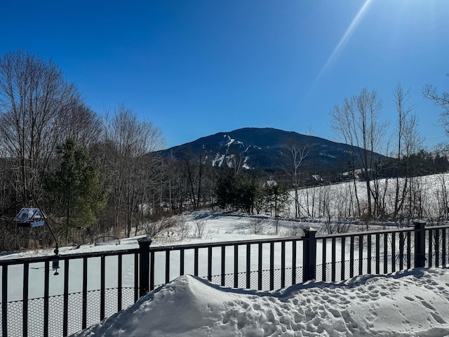 exterior space with a mountain view and fence