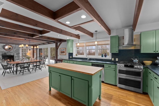 kitchen featuring green cabinetry, a sink, stainless steel appliances, exhaust hood, and butcher block counters