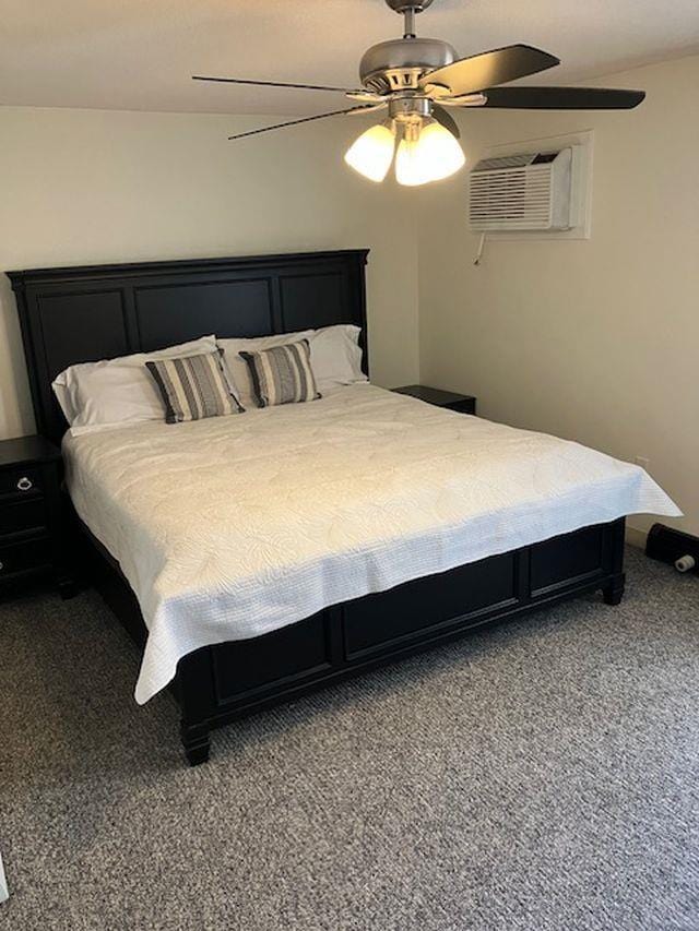 carpeted bedroom featuring a wall mounted air conditioner and ceiling fan