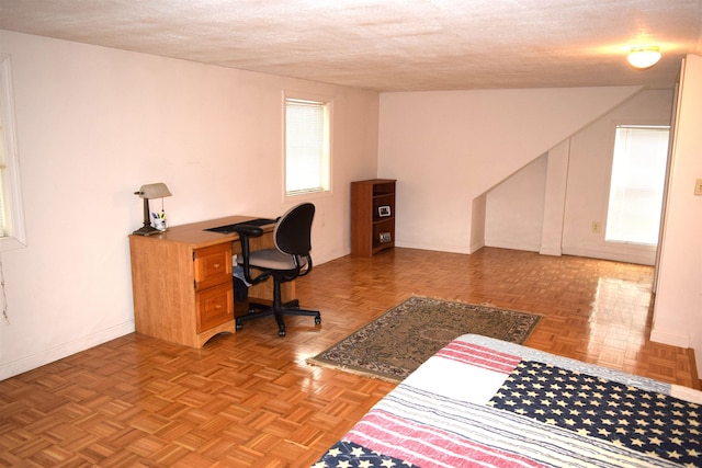 home office featuring a textured ceiling and baseboards