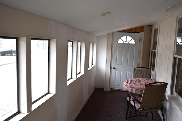 sunroom featuring lofted ceiling and visible vents