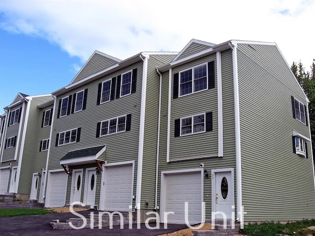 townhome / multi-family property featuring a garage and driveway