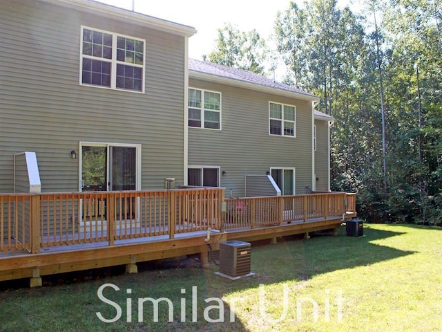 back of house featuring a yard, a wooden deck, and cooling unit