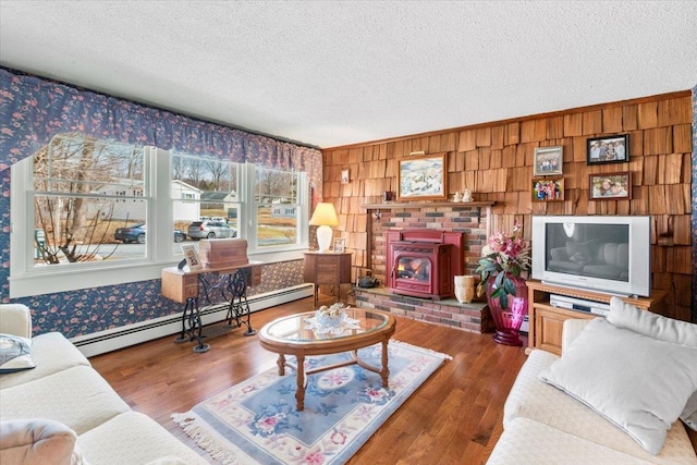 living room with a textured ceiling, wood finished floors, and a baseboard radiator