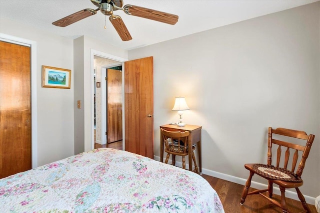 bedroom featuring a ceiling fan, wood finished floors, and baseboards