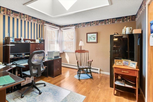 home office featuring a textured ceiling, wallpapered walls, baseboards, and wood finished floors