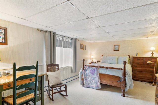 bedroom with baseboard heating, carpet, and a drop ceiling