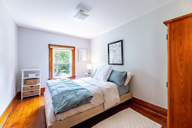 bedroom with baseboards and wood finished floors