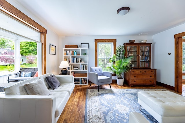 sitting room with visible vents, baseboards, and hardwood / wood-style flooring