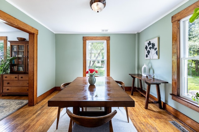 dining space featuring a wealth of natural light, visible vents, and light wood-type flooring