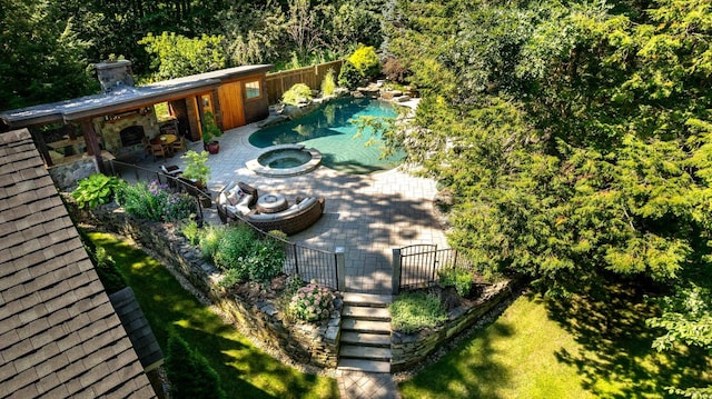 view of swimming pool featuring a fenced in pool, fence, an in ground hot tub, and a patio area