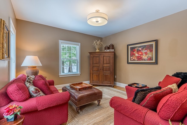 living room with light wood-type flooring and baseboards