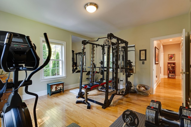 exercise area featuring baseboards and wood finished floors