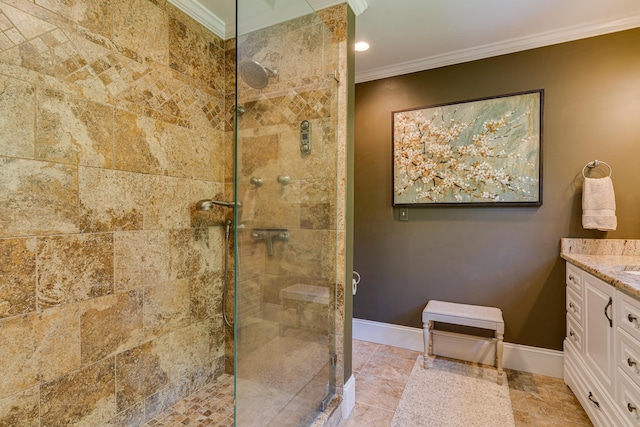 full bathroom featuring vanity, baseboards, a tile shower, and ornamental molding