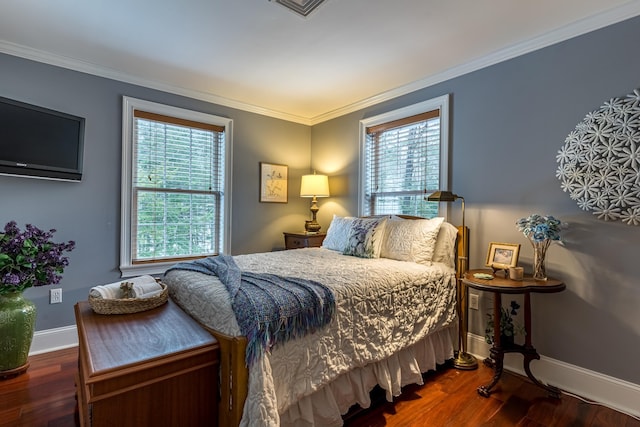 bedroom with multiple windows, wood finished floors, and crown molding