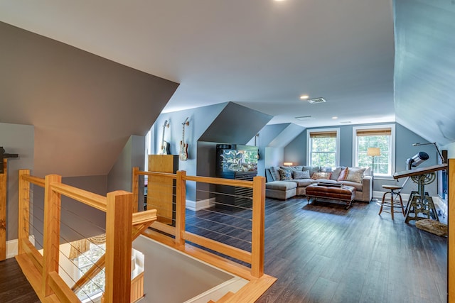 interior space with vaulted ceiling, wood finished floors, and visible vents