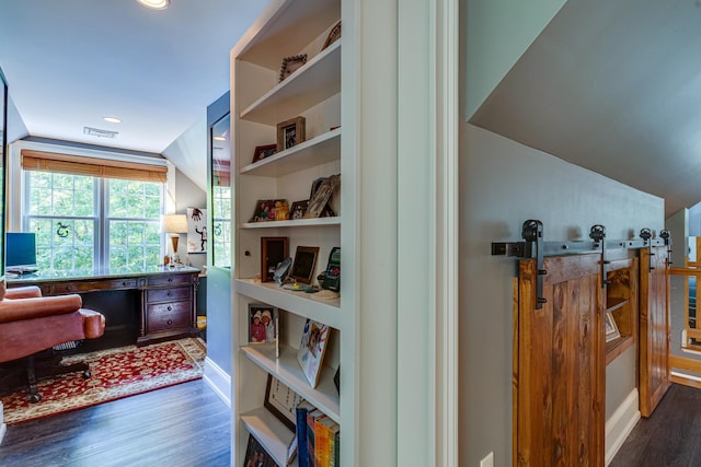 home office featuring visible vents, built in features, wood finished floors, recessed lighting, and lofted ceiling