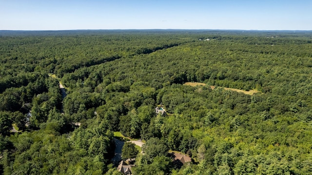 birds eye view of property with a view of trees