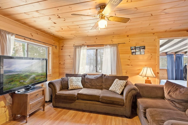 living area featuring plenty of natural light, light wood-style flooring, and wood ceiling