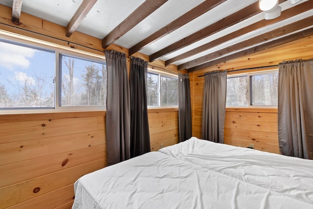 bedroom featuring vaulted ceiling with beams and wood walls