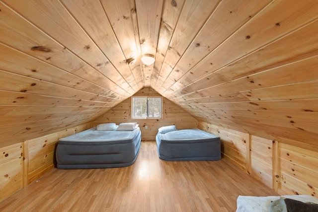 interior space featuring wooden walls, wood ceiling, wood finished floors, and vaulted ceiling