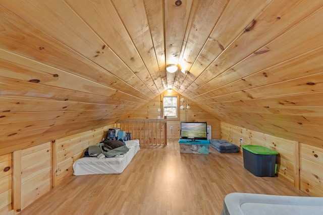 bonus room featuring wood walls, wooden ceiling, lofted ceiling, and wood finished floors