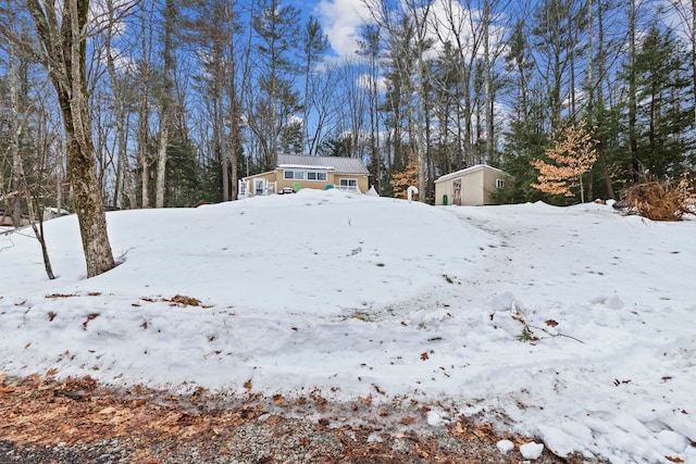 snowy yard with an outdoor structure