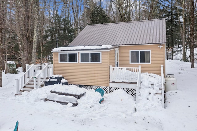 exterior space with metal roof and a wooden deck