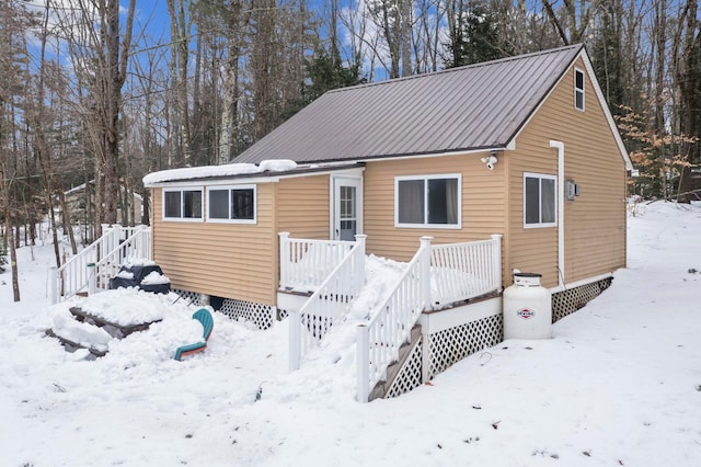 view of front of house featuring a deck and metal roof