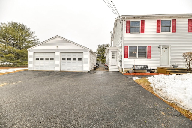 view of front of property with an outbuilding, entry steps, and a garage