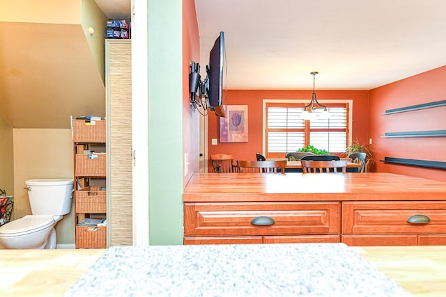 interior space with light countertops and pendant lighting