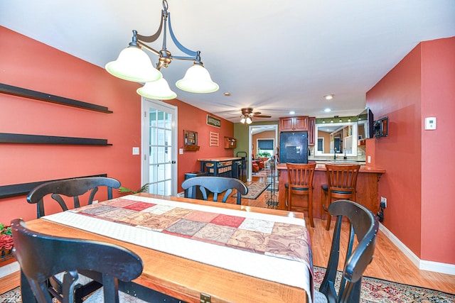 dining space with baseboards, light wood-type flooring, recessed lighting, french doors, and a ceiling fan