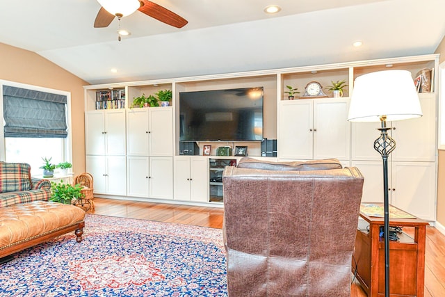 living room featuring recessed lighting, a ceiling fan, light wood-style floors, and vaulted ceiling