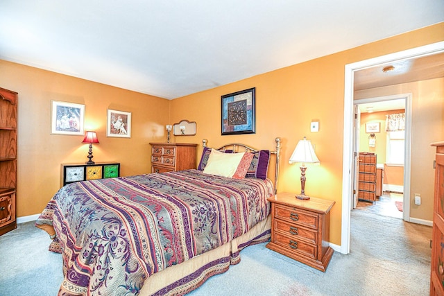 bedroom with baseboards and carpet floors