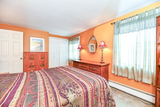 bedroom featuring multiple windows, carpet, a closet, and baseboard heating