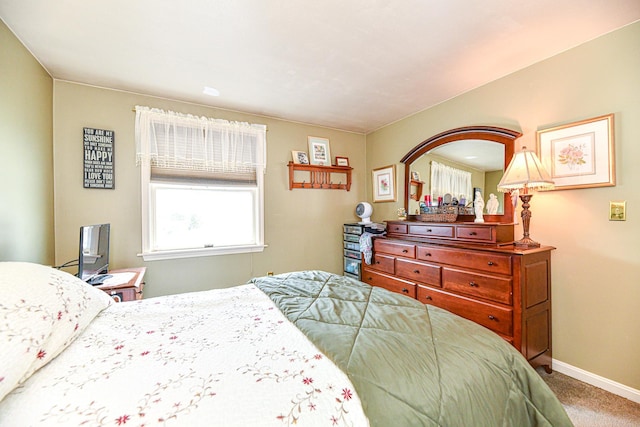 bedroom featuring carpet flooring and baseboards